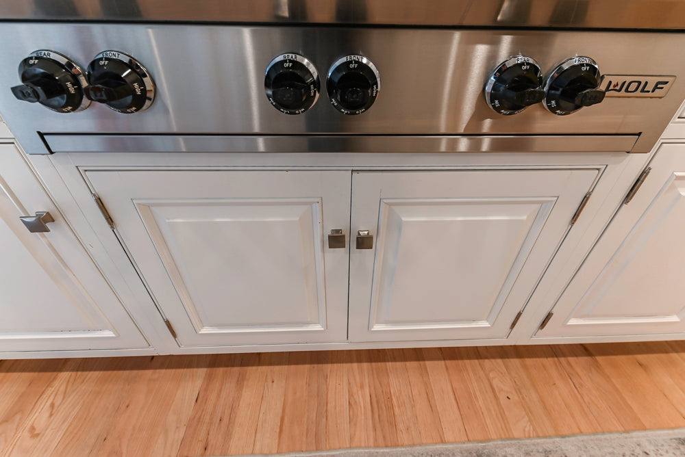 Traditional White Kitchen with Island, Appliances and Marble Countertops