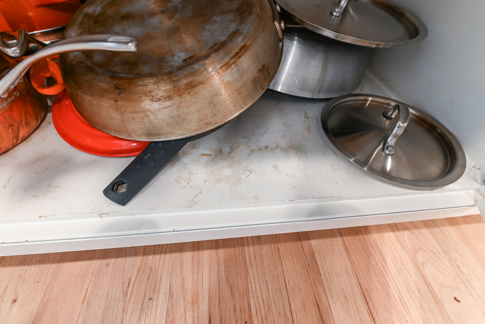 Traditional White Kitchen with Island, Appliances and Marble Countertops