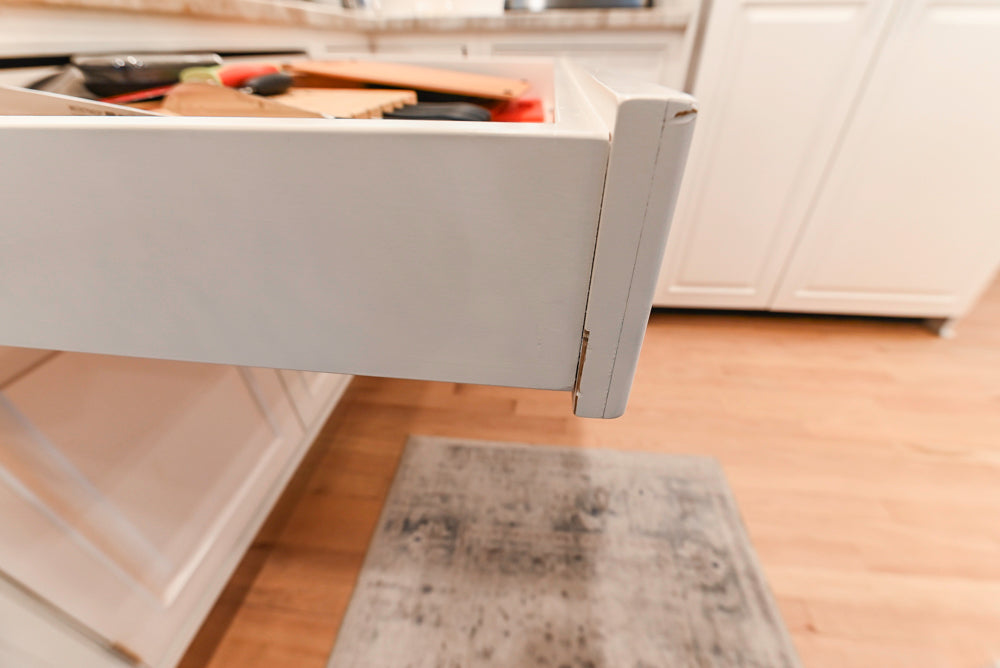 Traditional White Kitchen with Island, Appliances and Marble Countertops