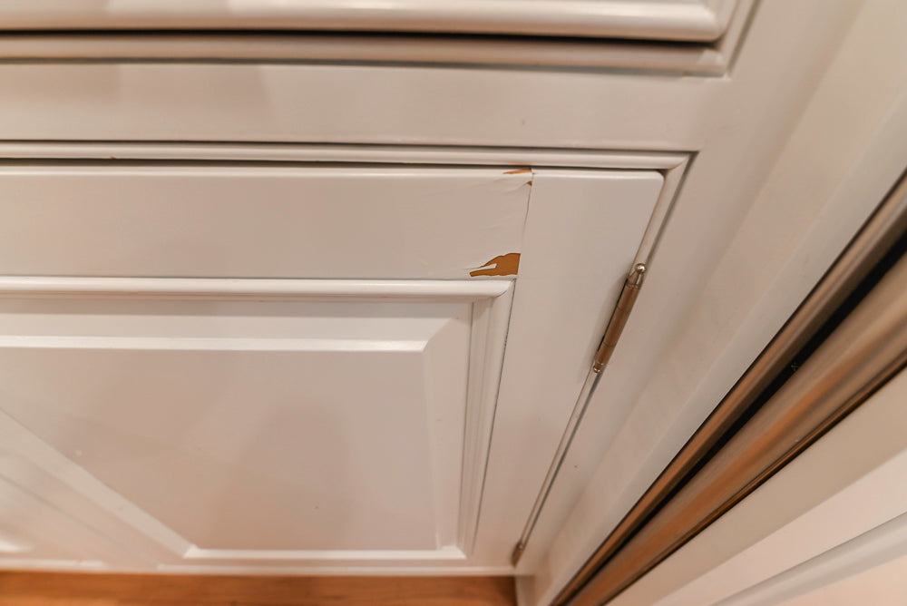 Traditional White Kitchen with Island, Appliances and Marble Countertops