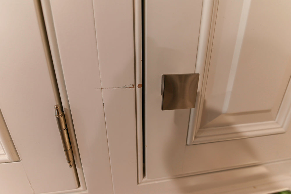 Traditional White Kitchen with Island, Appliances and Marble Countertops
