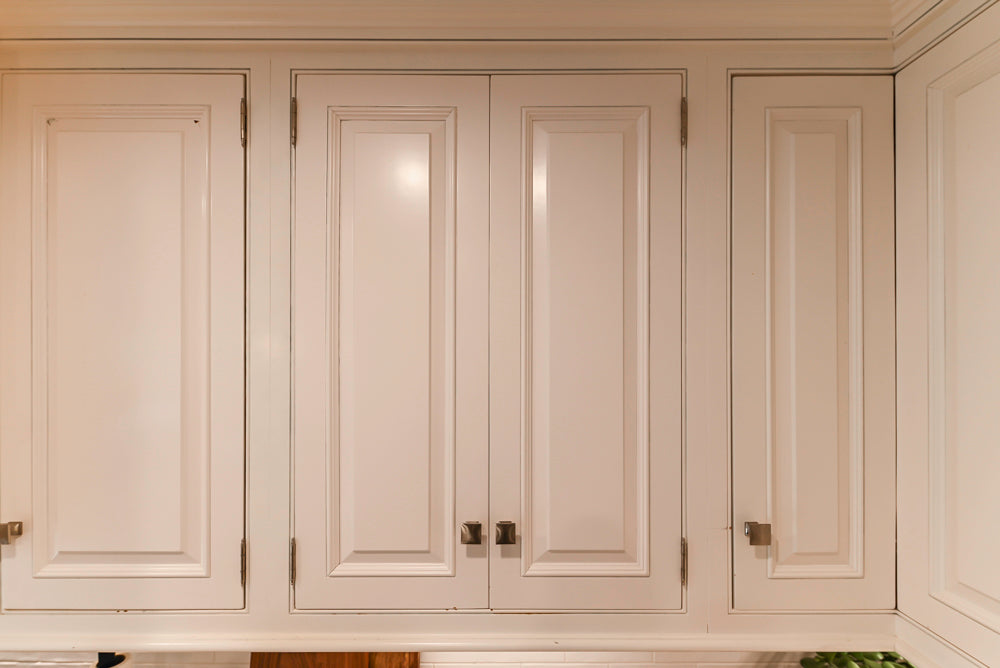 Traditional White Kitchen with Island, Appliances and Marble Countertops