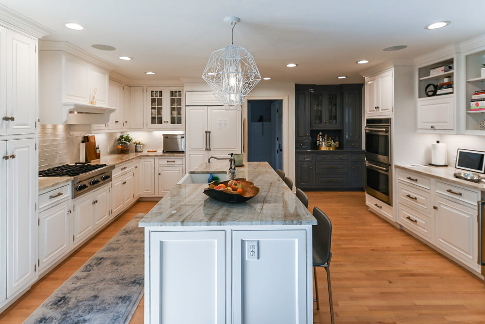 Traditional White Kitchen with Island, Appliances and Marble Countertops