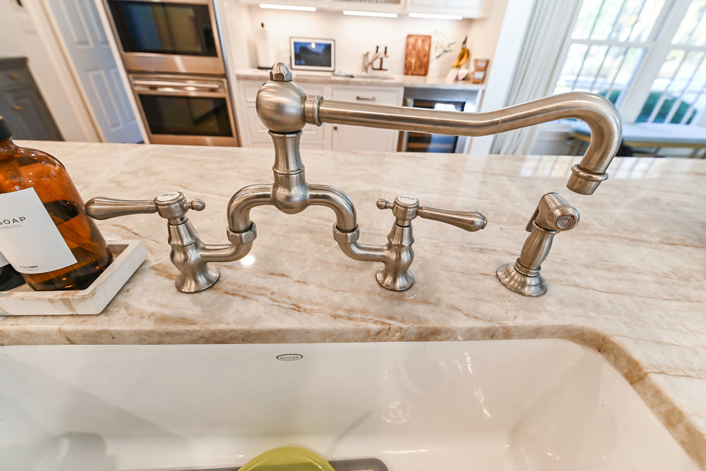 Traditional White Kitchen with Island, Appliances and Marble Countertops