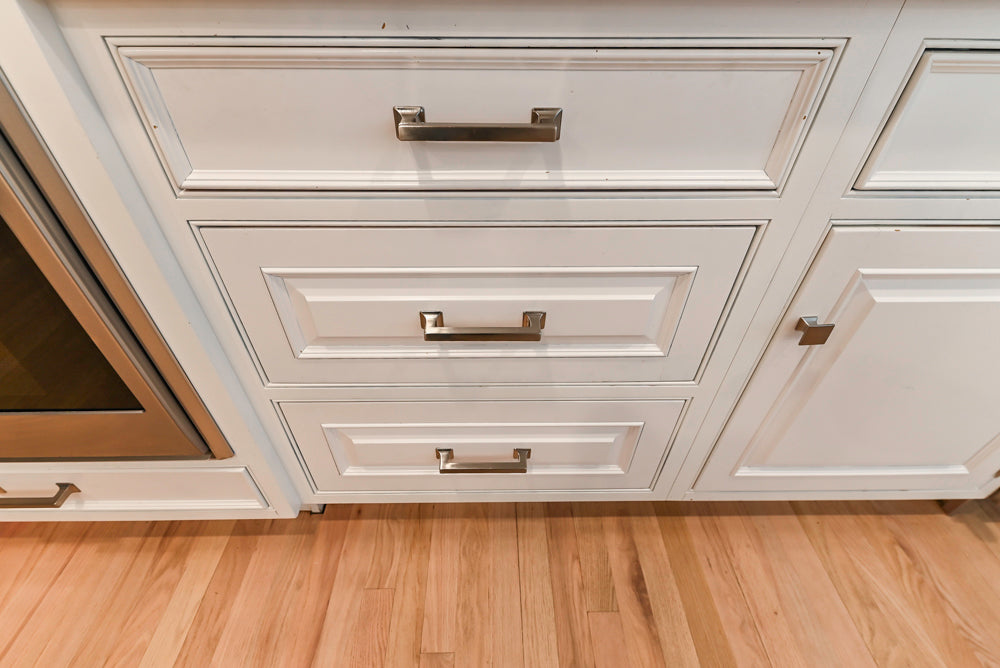 Traditional White Kitchen with Island, Appliances and Marble Countertops