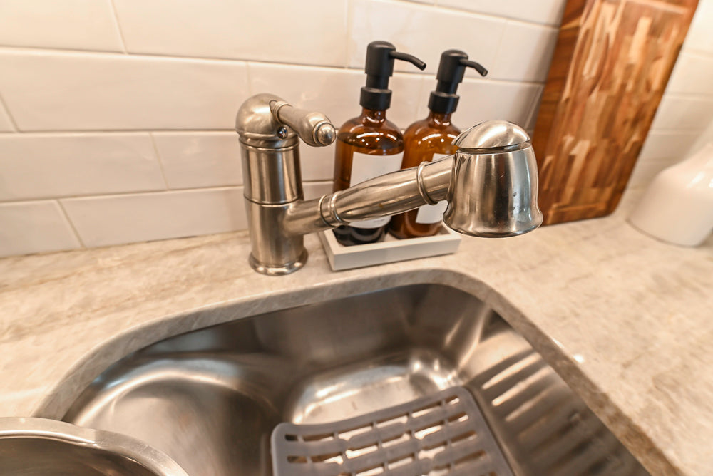 Traditional White Kitchen with Island, Appliances and Marble Countertops