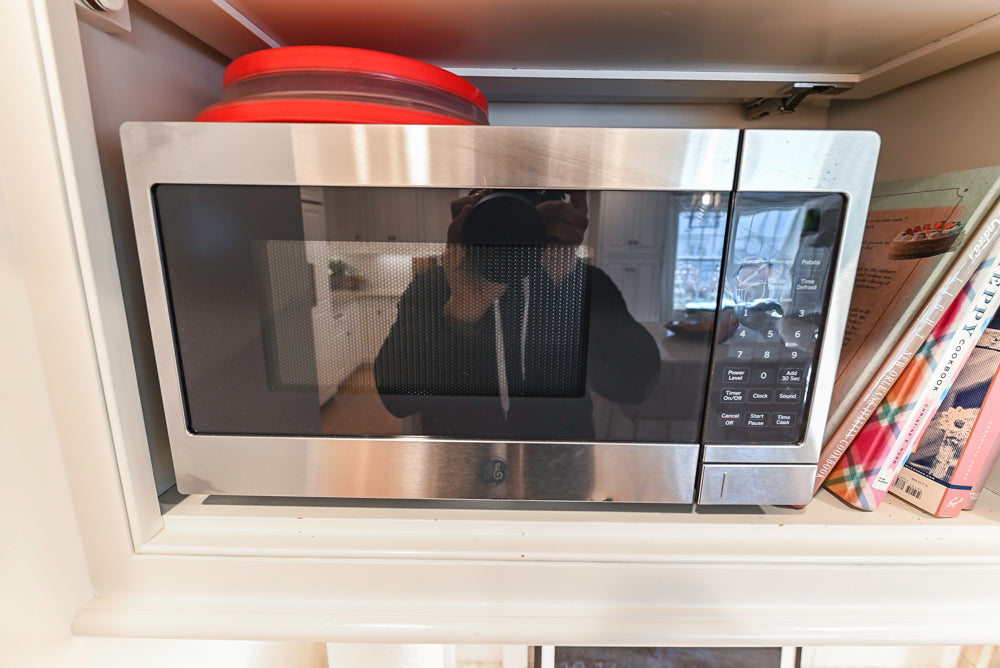 Traditional White Kitchen with Island, Appliances and Marble Countertops
