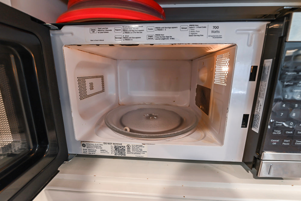 Traditional White Kitchen with Island, Appliances and Marble Countertops