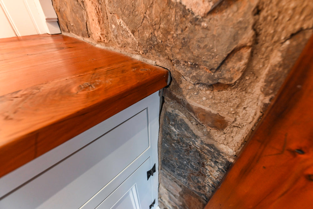 Rustic Traditional White & Navy Kitchen with Black AGA Range, Wood Top Island & Soapstone Countertops