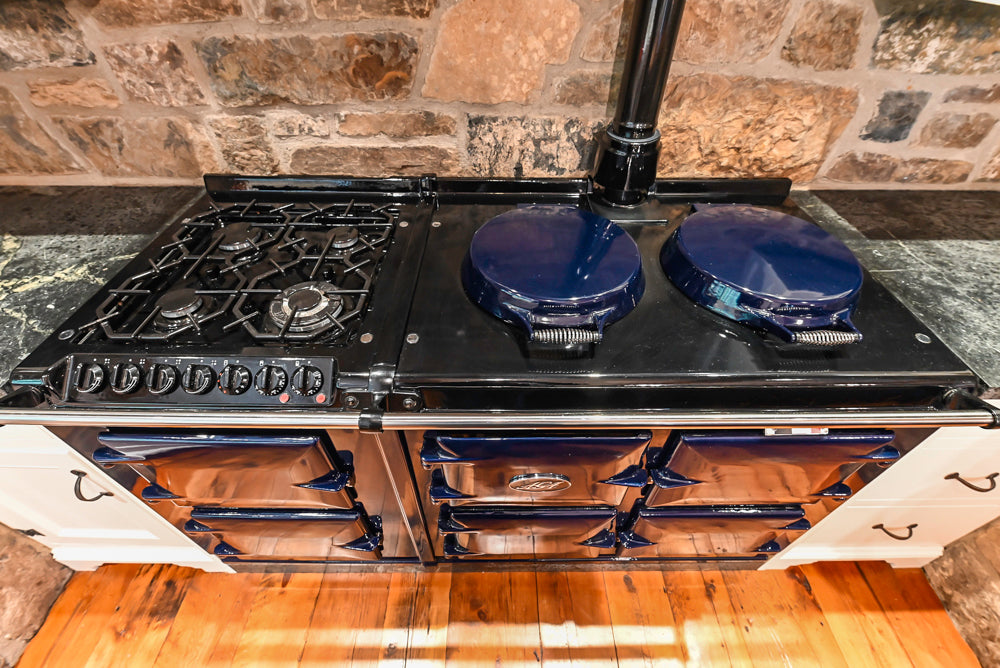 Rustic Traditional White & Navy Kitchen with Black AGA Range, Wood Top Island & Soapstone Countertops
