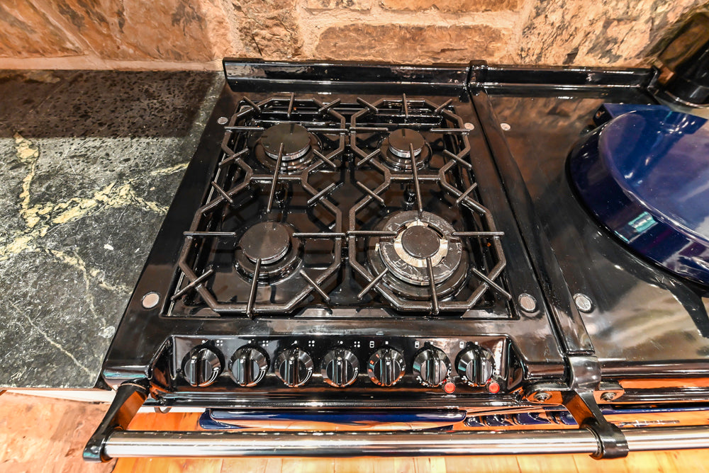 Rustic Traditional White & Navy Kitchen with Black AGA Range, Wood Top Island & Soapstone Countertops