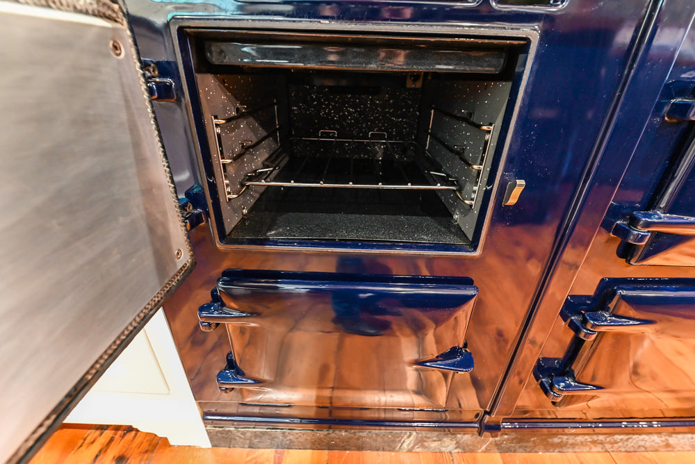 Rustic Traditional White & Navy Kitchen with Black AGA Range, Wood Top Island & Soapstone Countertops