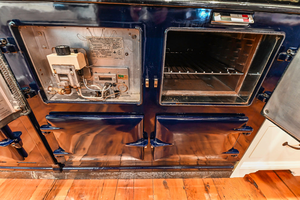 Rustic Traditional White & Navy Kitchen with Black AGA Range, Wood Top Island & Soapstone Countertops