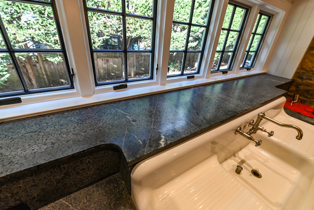 Rustic Traditional White & Navy Kitchen with Black AGA Range, Wood Top Island & Soapstone Countertops