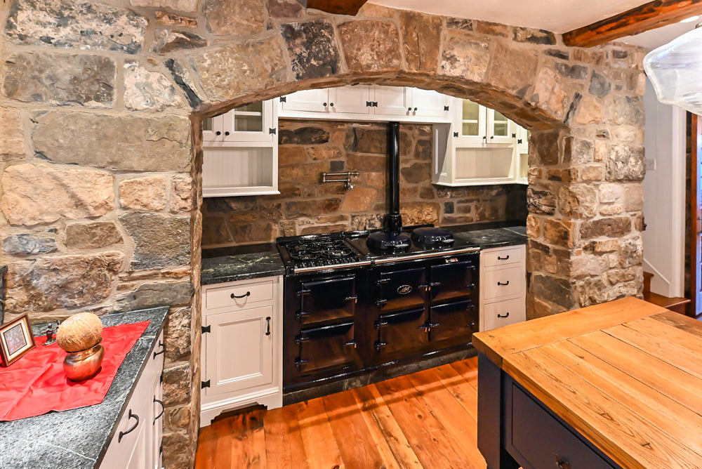 Rustic Traditional White & Navy Kitchen with Black AGA Range, Wood Top Island & Soapstone Countertops