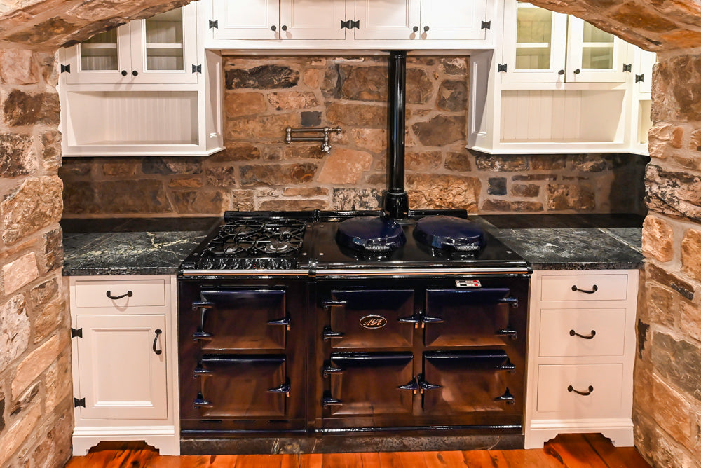 Rustic Traditional White & Navy Kitchen with Black AGA Range, Wood Top Island & Soapstone Countertops