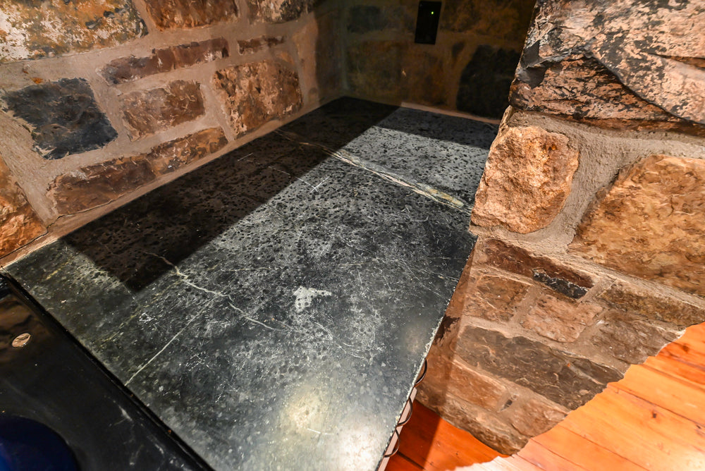 Rustic Traditional White & Navy Kitchen with Black AGA Range, Wood Top Island & Soapstone Countertops