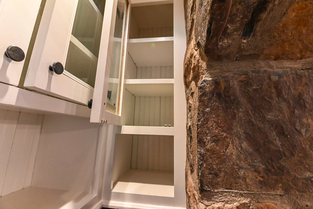 Rustic Traditional White & Navy Kitchen with Black AGA Range, Wood Top Island & Soapstone Countertops