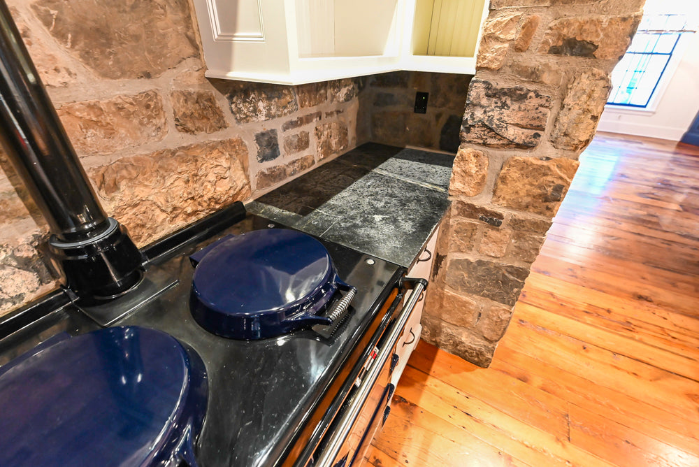 Rustic Traditional White & Navy Kitchen with Black AGA Range, Wood Top Island & Soapstone Countertops