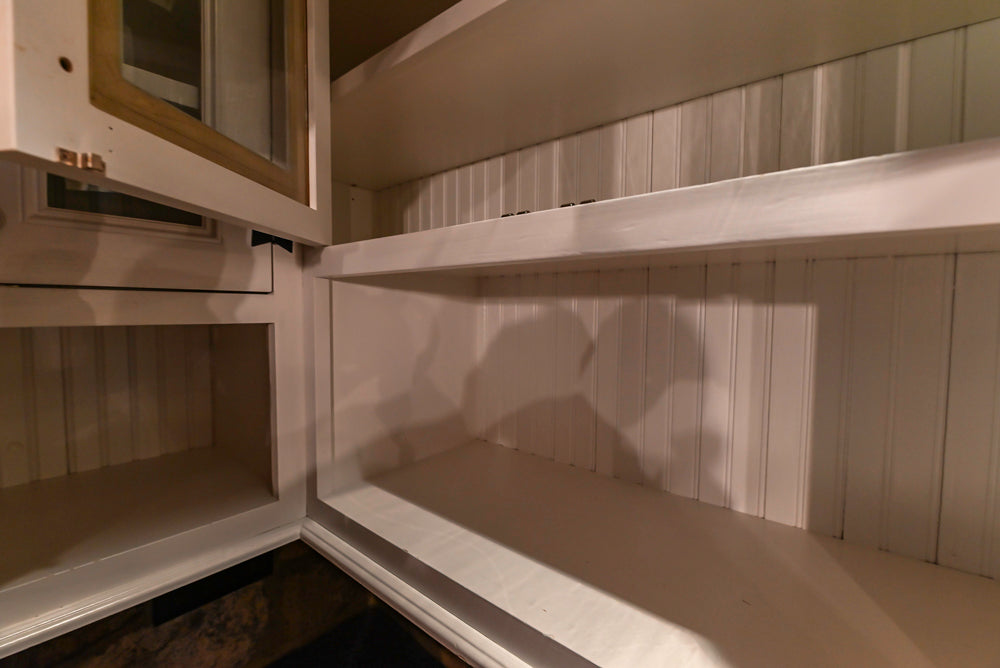 Rustic Traditional White & Navy Kitchen with Black AGA Range, Wood Top Island & Soapstone Countertops