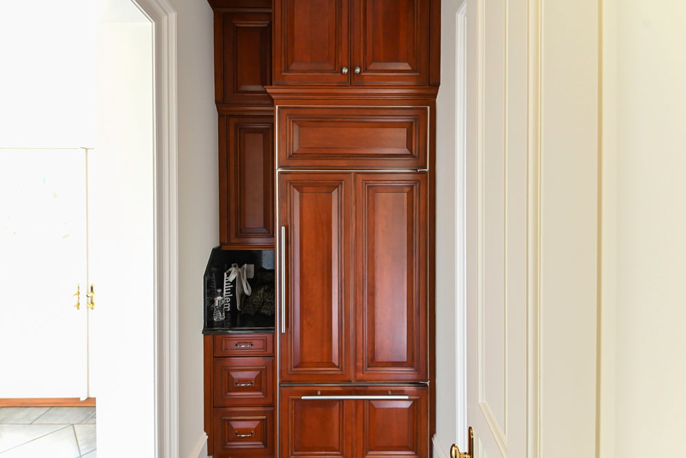 Wood-Mode Traditional Pantry with Dark Granite Countertop & Sub-Zero Refrigerator