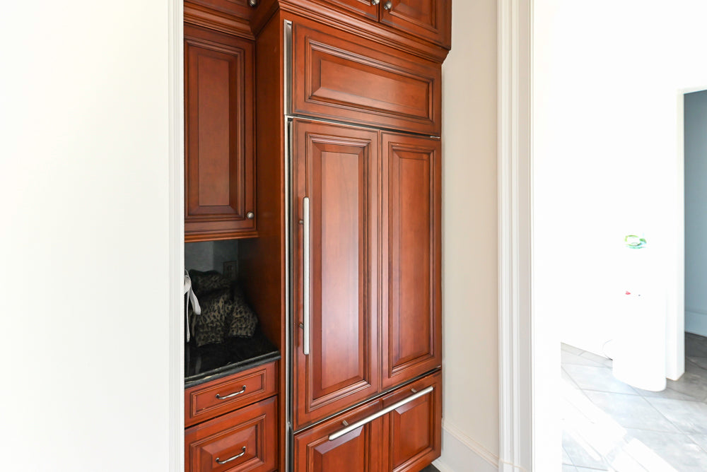 Wood-Mode Traditional Pantry with Dark Granite Countertop & Sub-Zero Refrigerator