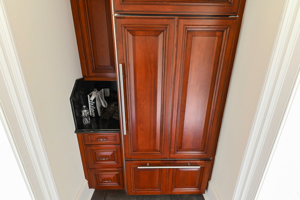 Wood-Mode Traditional Pantry with Dark Granite Countertop & Sub-Zero Refrigerator