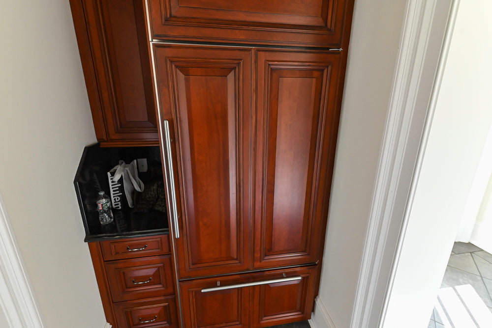Wood-Mode Traditional Pantry with Dark Granite Countertop & Sub-Zero Refrigerator