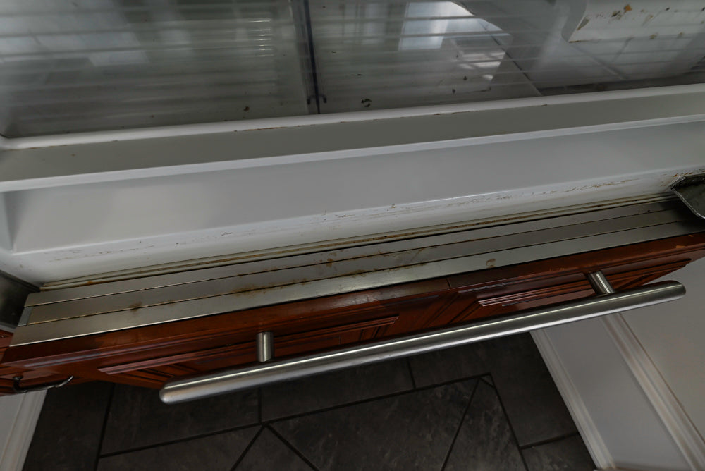 Wood-Mode Traditional Pantry with Dark Granite Countertop & Sub-Zero Refrigerator