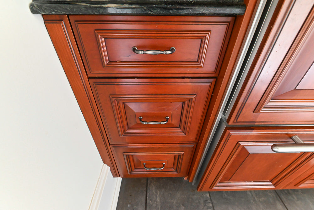 Wood-Mode Traditional Pantry with Dark Granite Countertop & Sub-Zero Refrigerator
