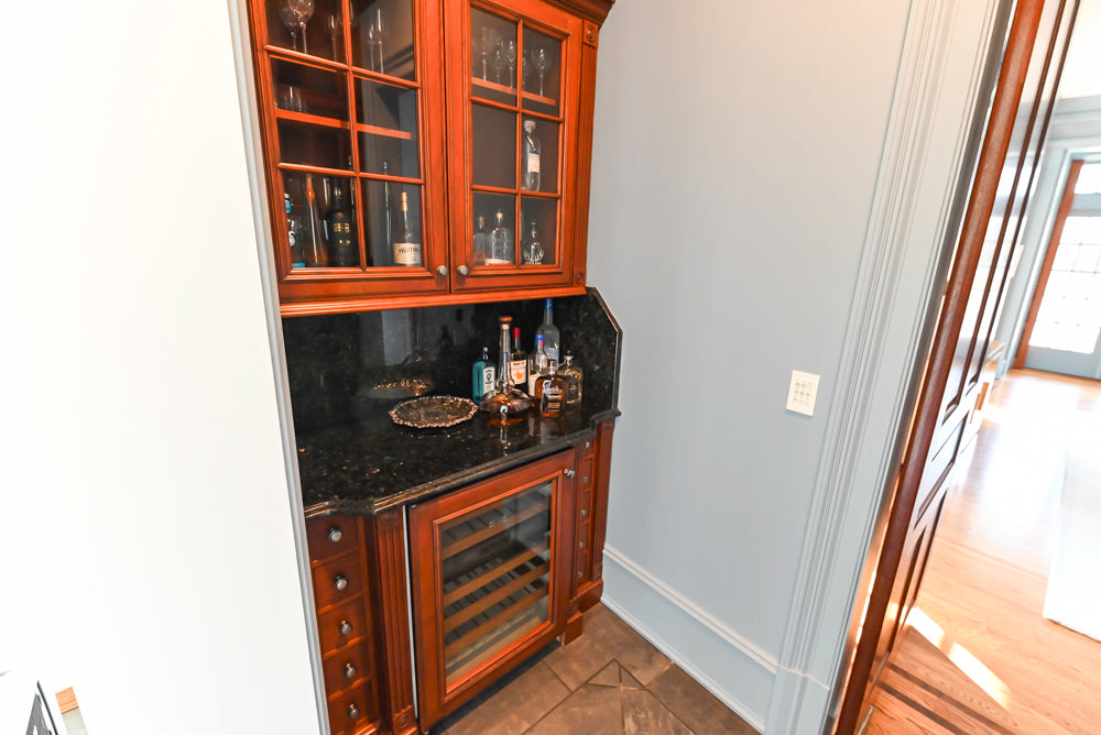 Wood-Mode Traditional Wet Bar with Dark Granite Countertops & Sub-Zero Wine Cooler