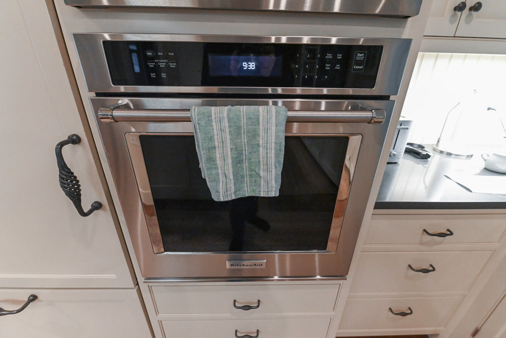 Large Traditional White Kitchen with Island, Stone Countertops & Desk Area