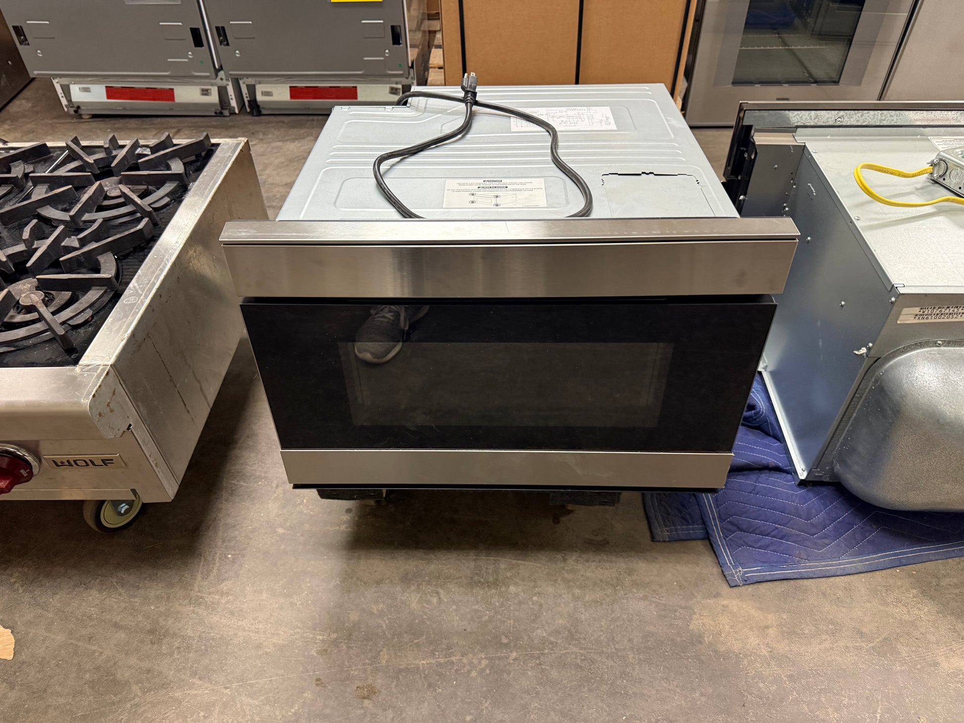 Sharp 24 inch smart microwave drawer in stainless steel installed in cabinetry
