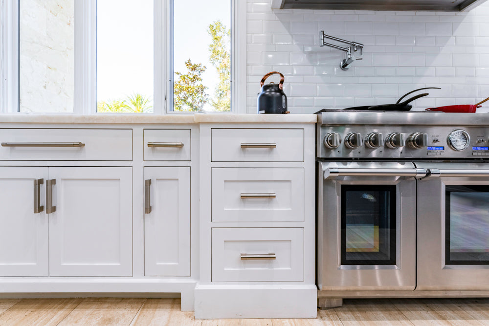 Transitional White Kitchen with Marble Countertops and Grand Island with Seating