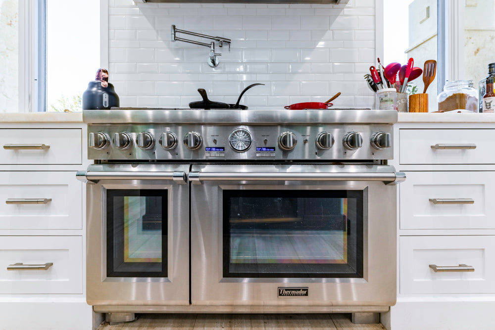 Transitional White Kitchen with Marble Countertops and Grand Island with Seating
