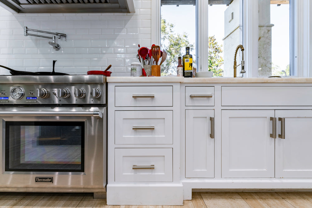 Transitional White Kitchen with Marble Countertops and Grand Island with Seating