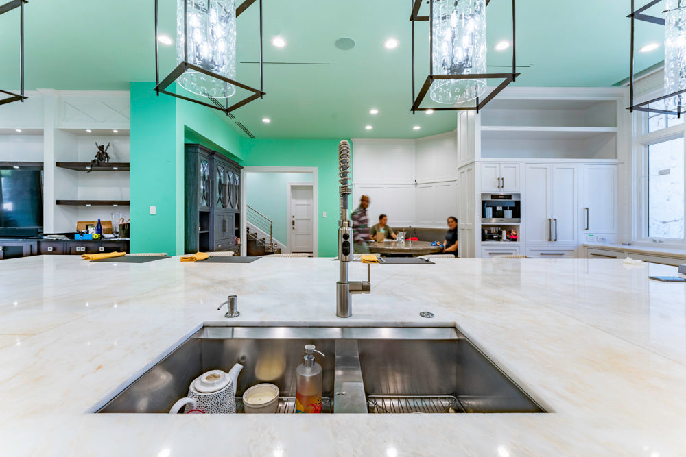 Transitional White Kitchen with Marble Countertops and Grand Island with Seating