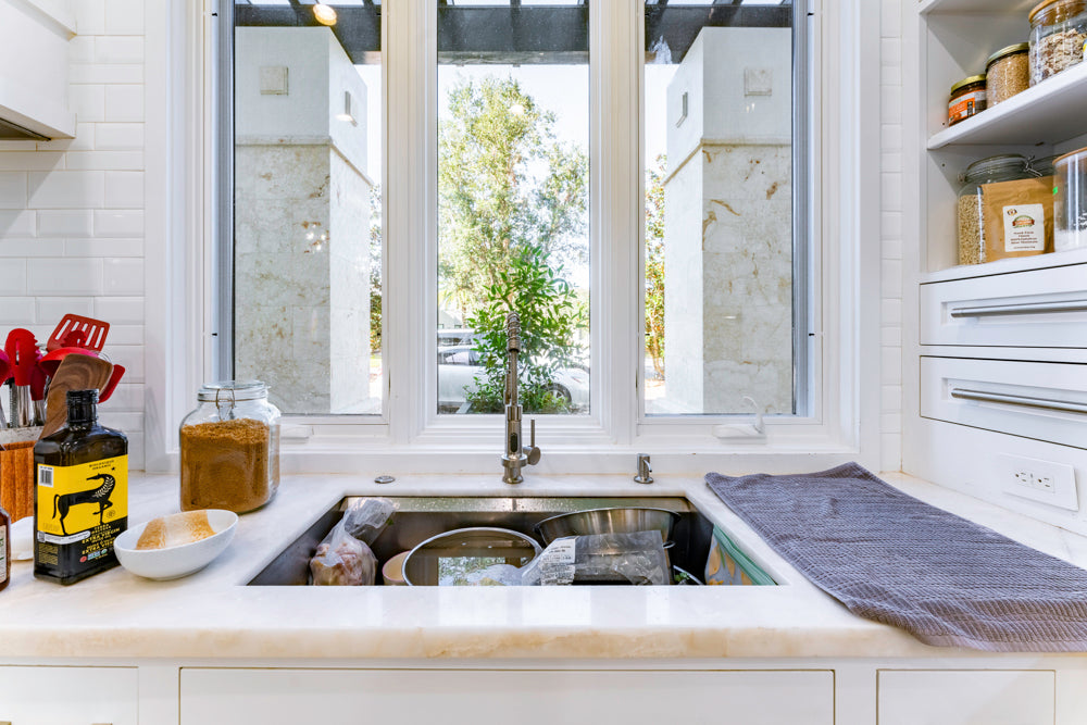 Transitional White Kitchen with Marble Countertops and Grand Island with Seating