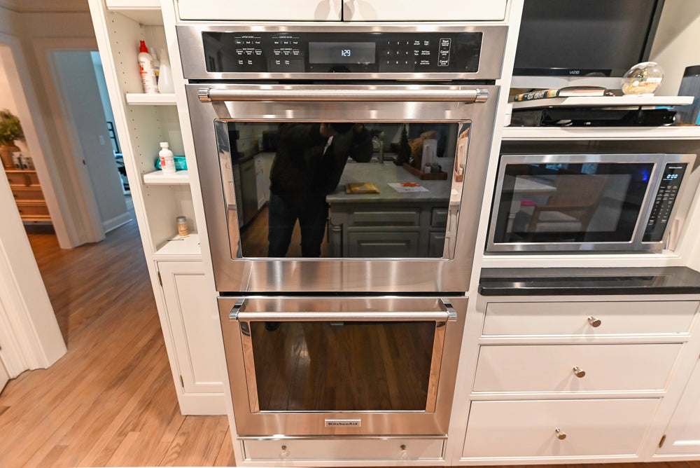 Traditional White Kitchen with Marble Top Island and Appliances