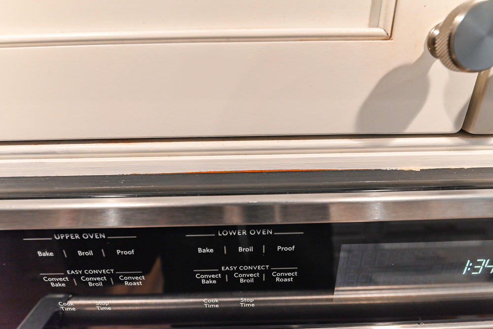 Traditional White Kitchen with Marble Top Island and Appliances