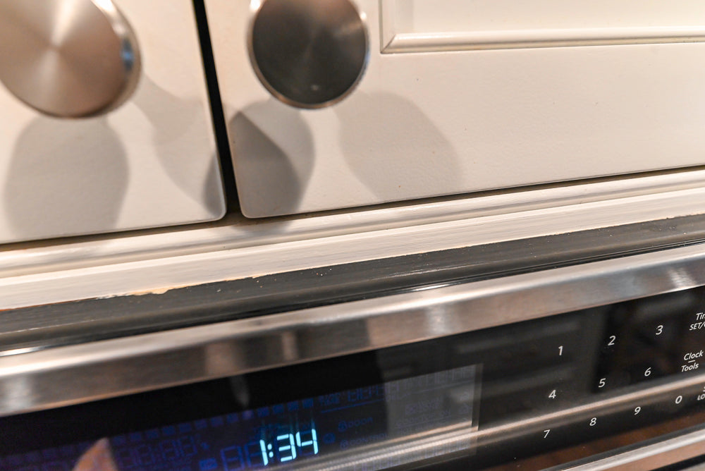 Traditional White Kitchen with Marble Top Island and Appliances