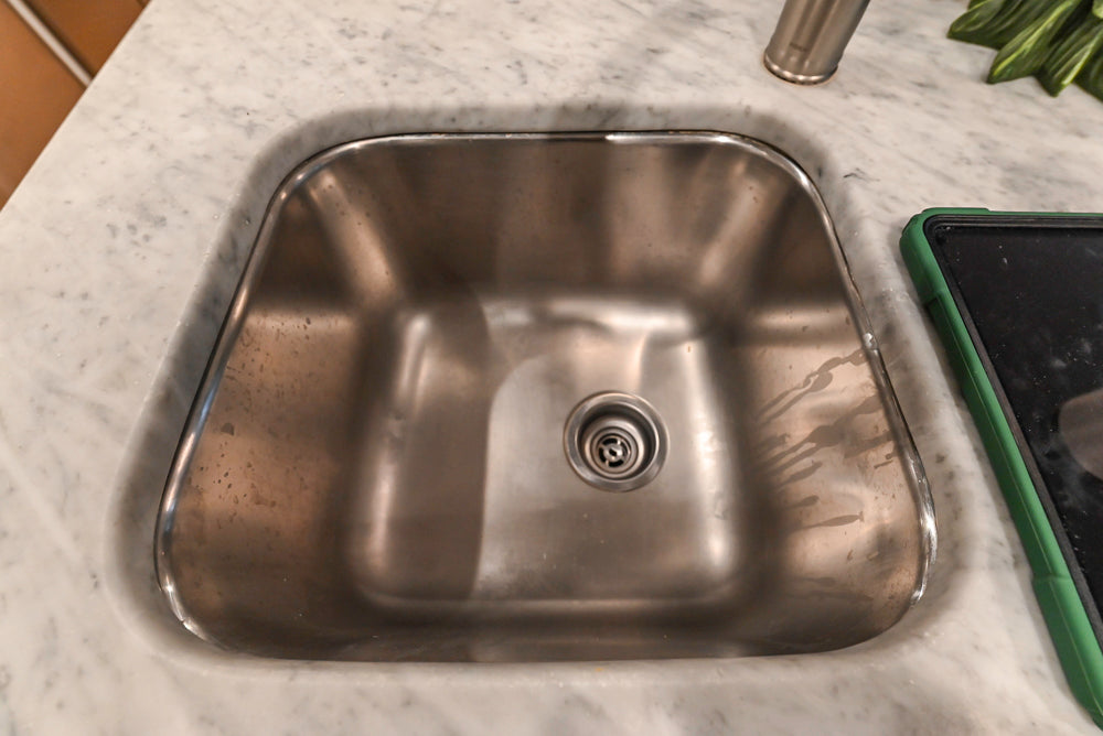 Traditional White Kitchen with Marble Top Island and Appliances