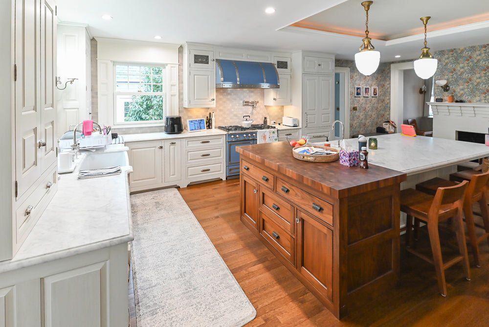 Traditional White Kitchen with Island, Marble Countertops and La Cornue Range with Matching Hood