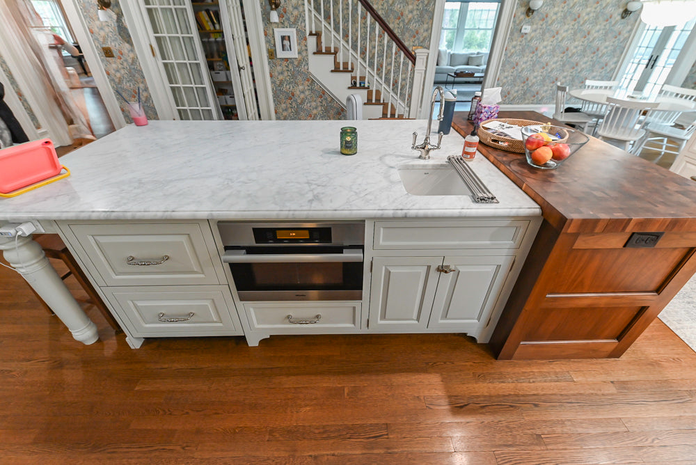 Traditional White Kitchen with Island, Marble Countertops and La Cornue Range with Matching Hood