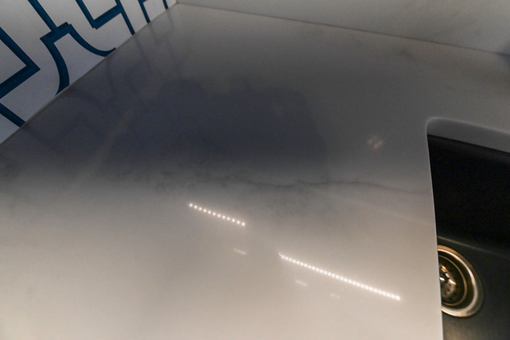 Gemcraft Navy Blue Pantry with White Quartz Countertops and Sub-Zero Tall Wine Cooler