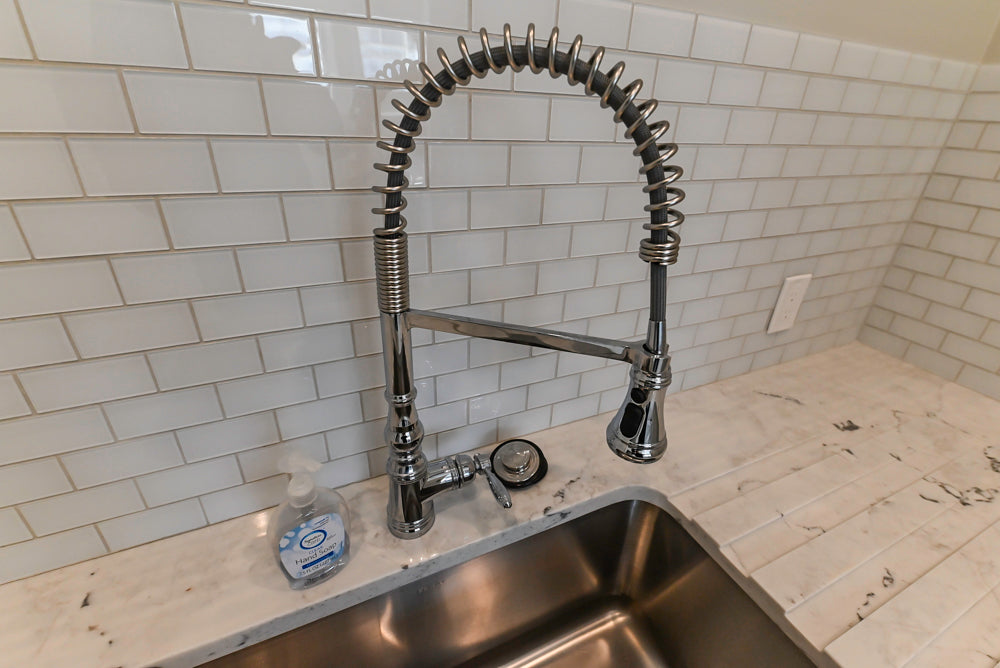 Traditional White Laundry Area with Sink, Faucet and Marble Countertops