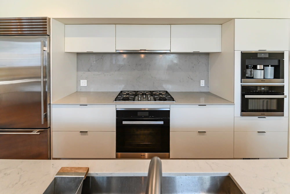 Modern Matte White Kitchen with Waterfall Island, Quartz Countertops & Miele Appliances