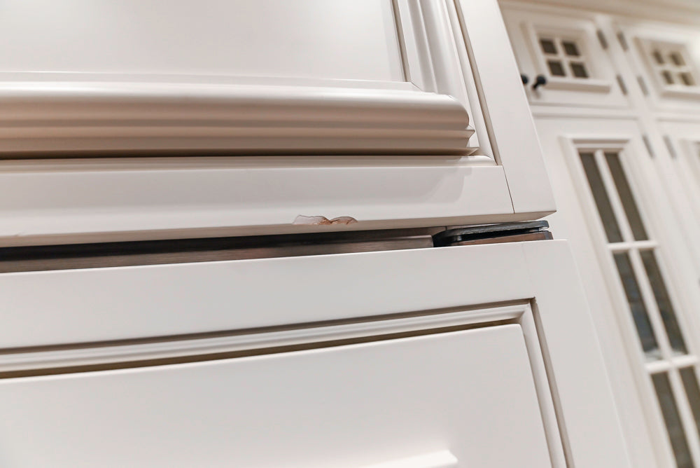 Quakermaid Traditional White Kitchen with Marble Countertops and Luxe Appliances