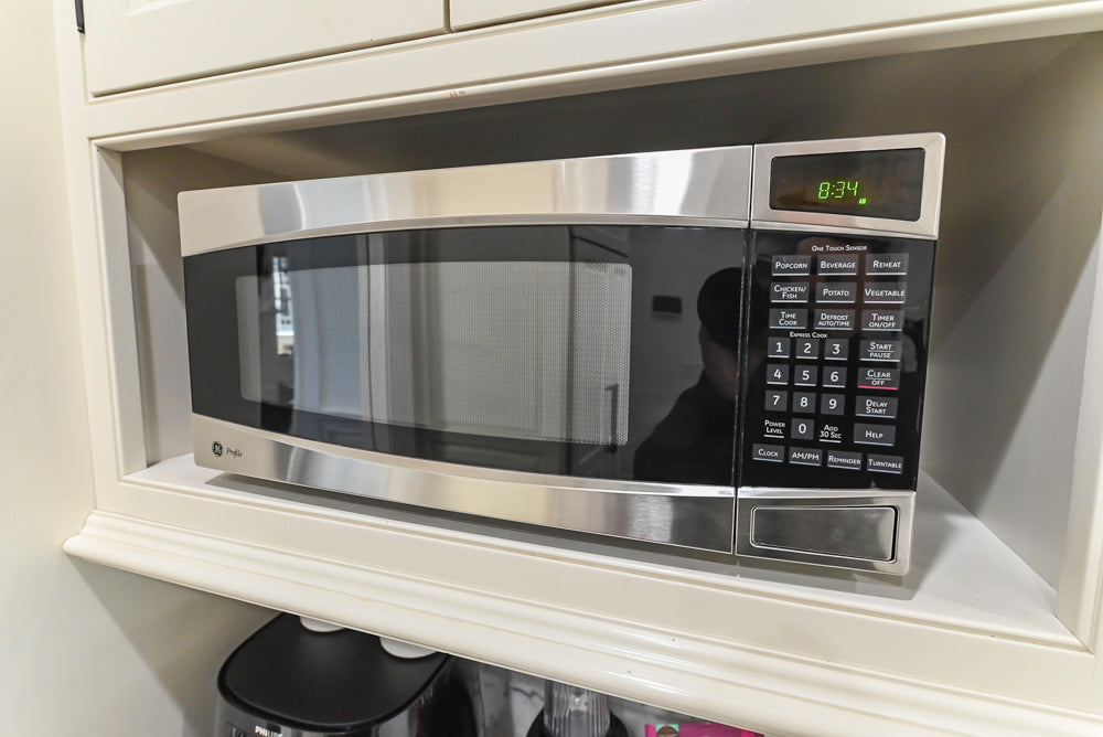 Traditional Creamy White Kitchen with Island, Marble Countertops and Appliances