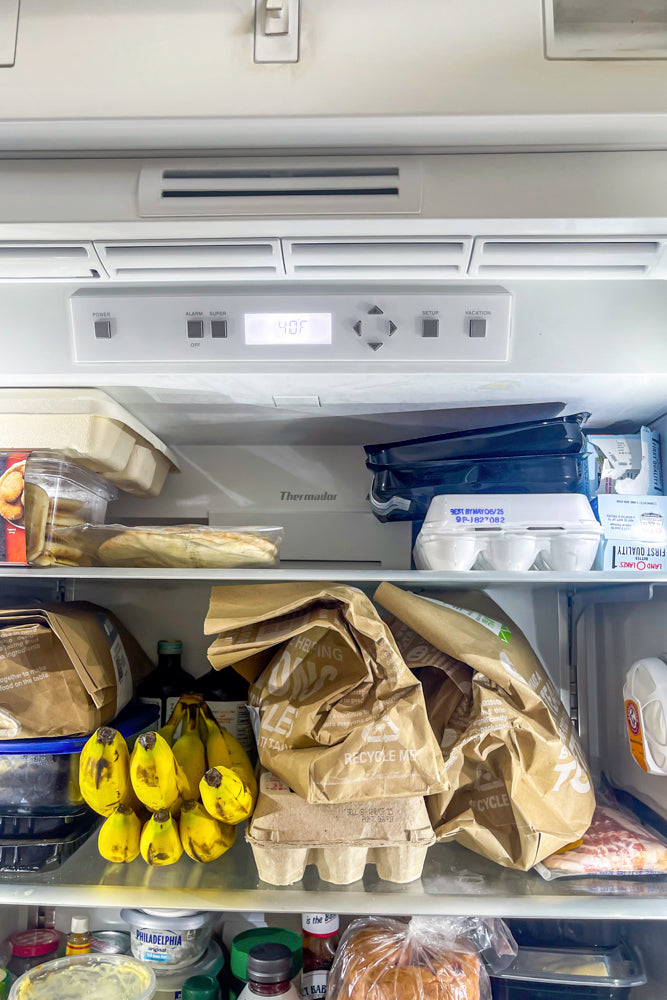 Transitional White Kitchen with Marble Waterfall Island and Thermador Appliances